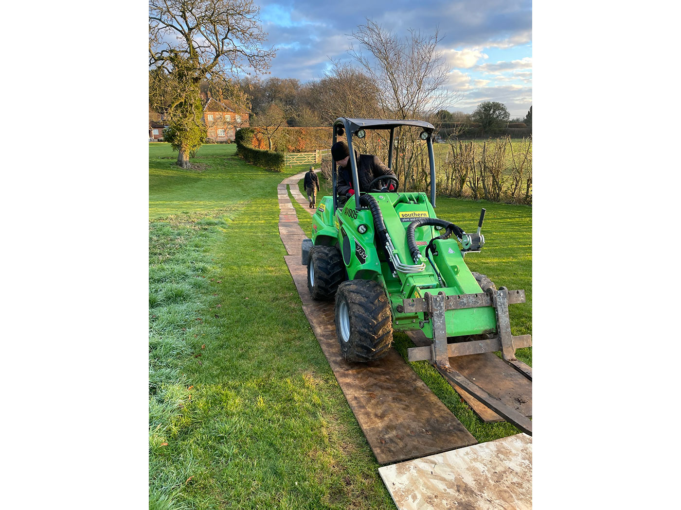 Avant for lifting and planting trees in use by Vincent Fencing